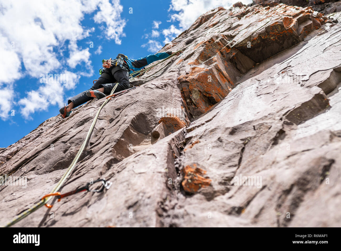 The last movements to reach the summit by a male climber. Rock climbing inside Andes mountains and valleys at Cajon del Maipo, an amazing place Stock Photo