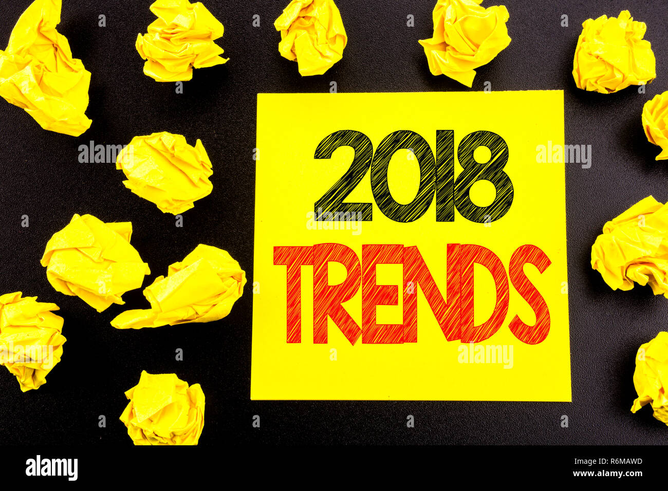 Conceptual hand writing text showing 2018 Trends. Business concept for Trending Data Prediction written on sticky note paper. Folded yellow papers on the background Stock Photo