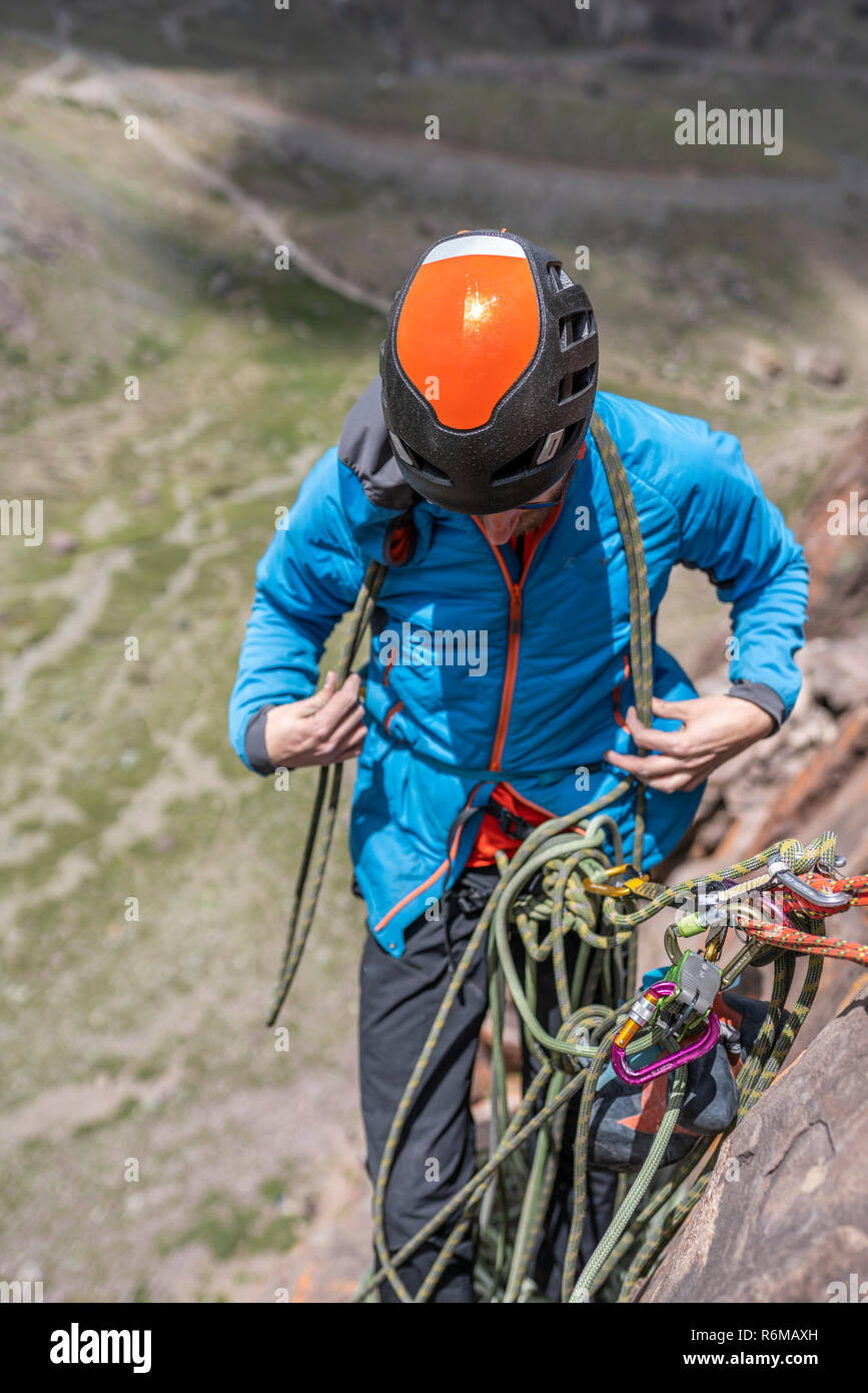 Face expressions while a climber climb a big wall inside the Andes, an
