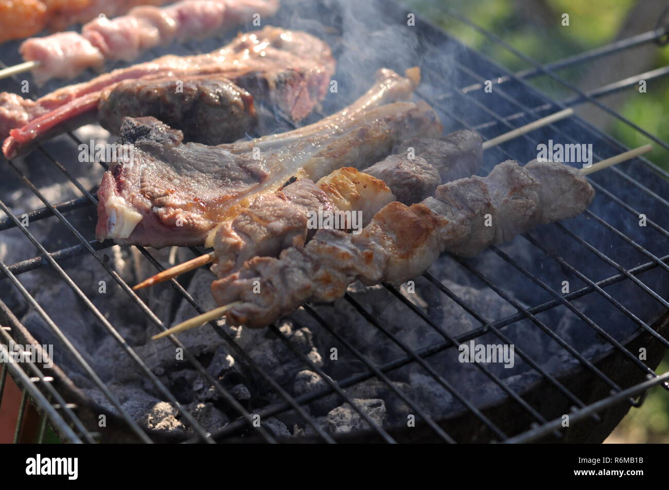 Traditional Cypriot meze and kebap barbecue party in the garden with ...
