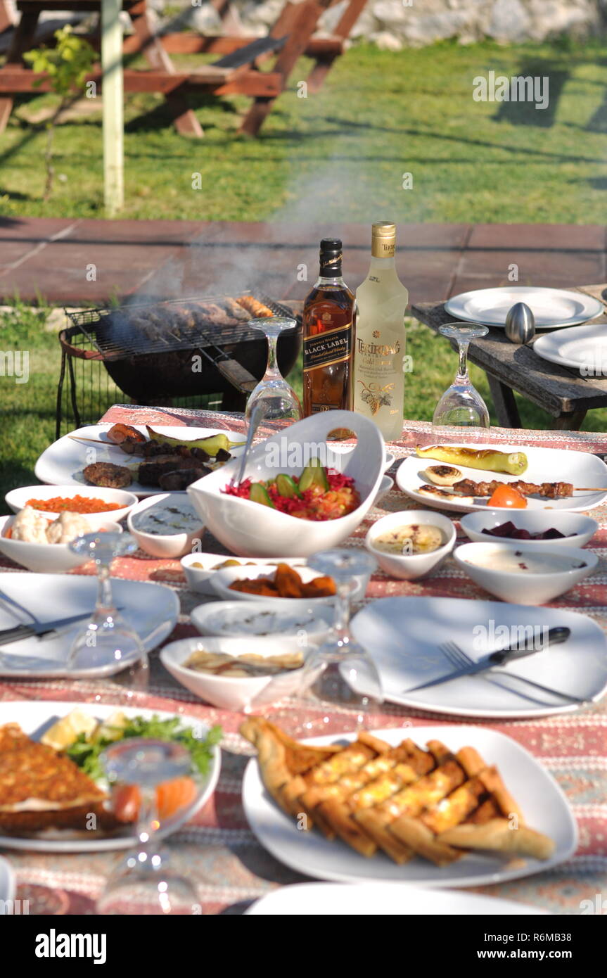 Traditional Cypriot meze and kebap barbecue party in the garden with delicious mix meat and chicken kebaps Stock Photo
