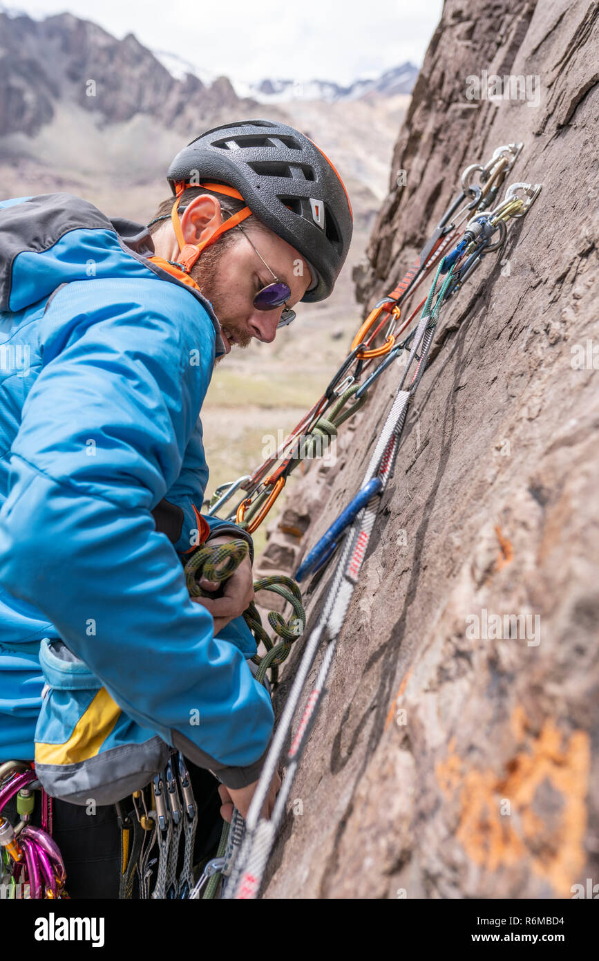 Face expressions while a climber climb a big wall inside the Andes, an