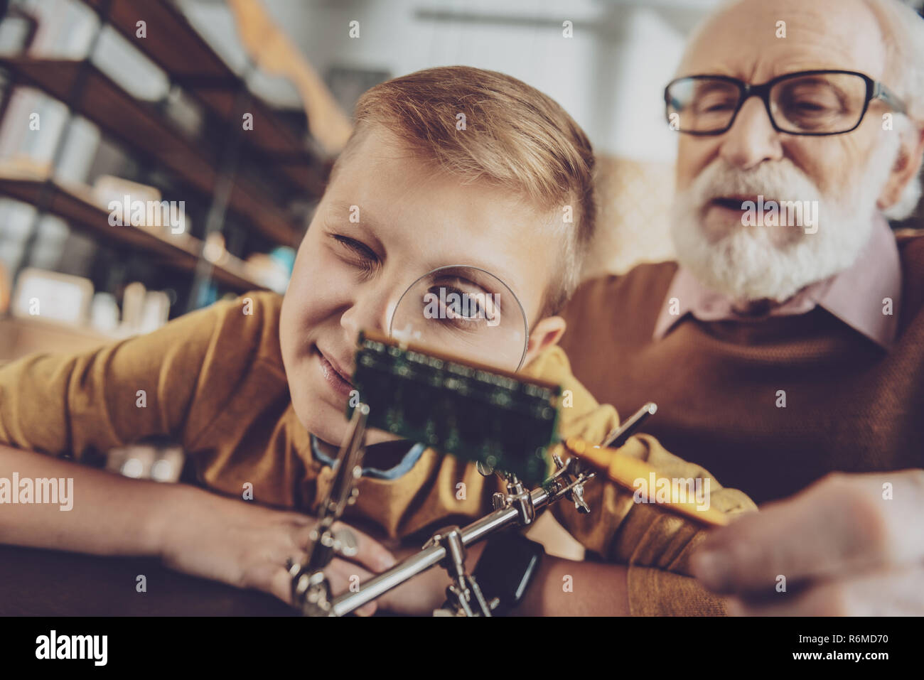 Close up of enigmatical boy that studying electronics Stock Photo