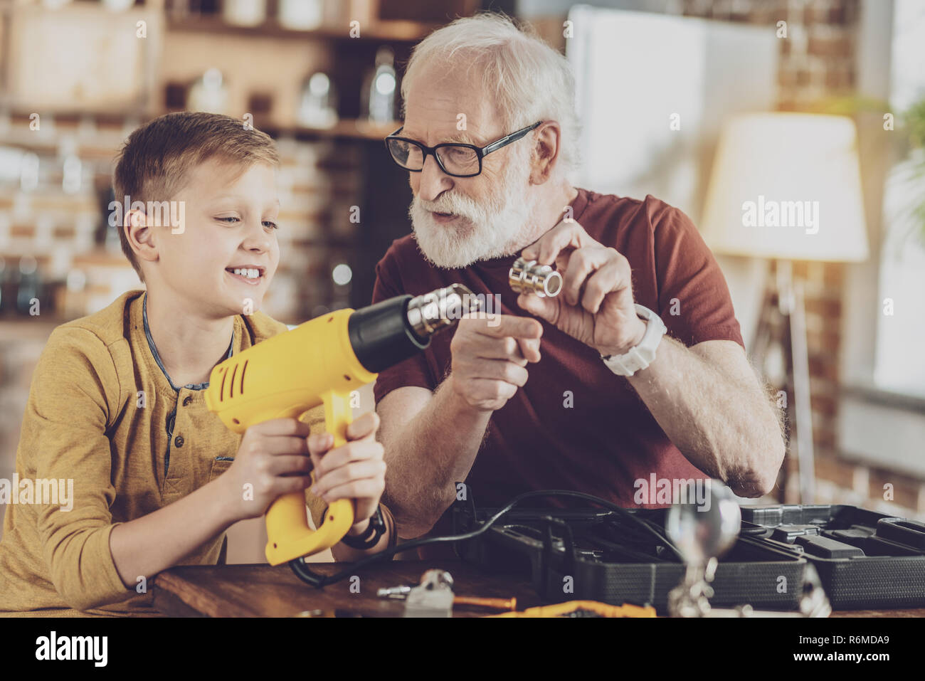 Positive delighted males being in their workshop Stock Photo