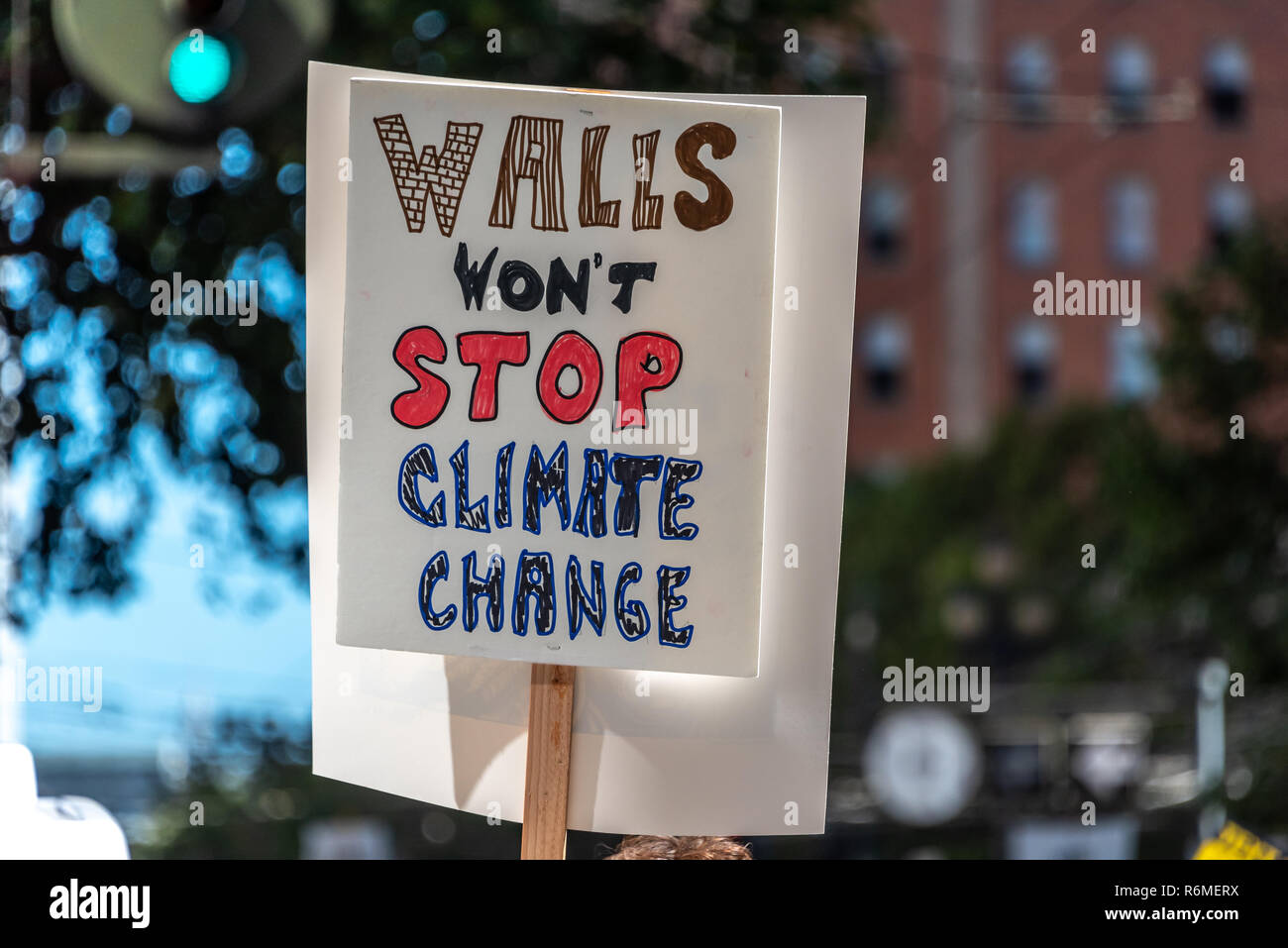 San Francisco, California, USA. 8th September, 2018. Thousands gather in San Francisco in Rise for Climate rally and march in advance of the Global Climate Action Summit to be held there September 12 to 14. A sign rises above the crowd reading 'Walls won't stop climate change' in reference to President Trump's proposed border wall project. Stock Photo