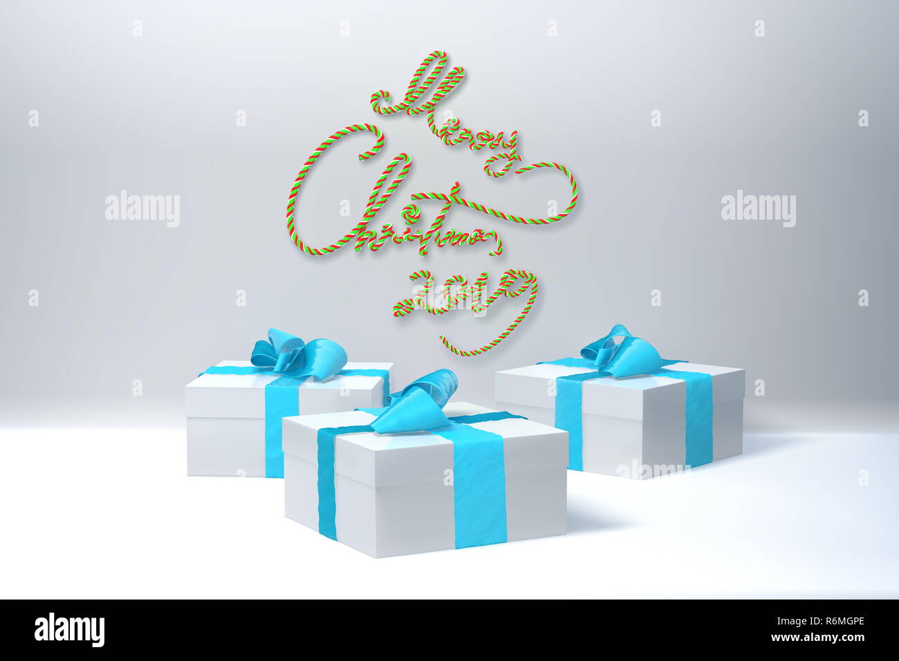 Merry Christmas 2019 lettering written in white color wall and three present gift boxes with bows beside. 3d illustration Stock Photo