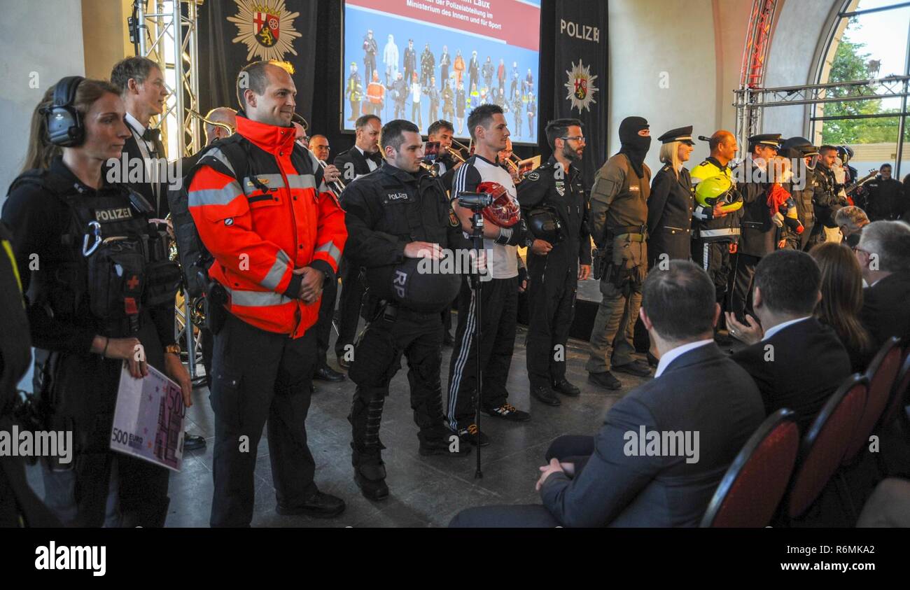 Members of the Rhineland-Palatinate (RLP) Polizei display the various uniforms and jobs they hold during the RLP Polizei’s 70th year anniversary celebration in Koblenz, Germany, May 20, 2017. The celebration included the induction of 551 candidates into the Polizei, German police force. Stock Photo