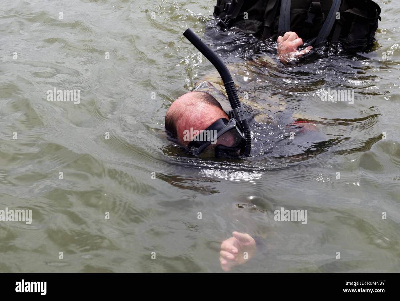 Master Sgt. Clinton Woodford, 181st Weather Flight special operations weatherman, swims to the recovery boat with his gear after a deliberate water drop into Lake Worth in Forth Worth, Texas,  May 20, 2017. The jump was part of an exercise to train on tactical skills when operating in hostile and denied territories. (Texas Air National Guard Stock Photo