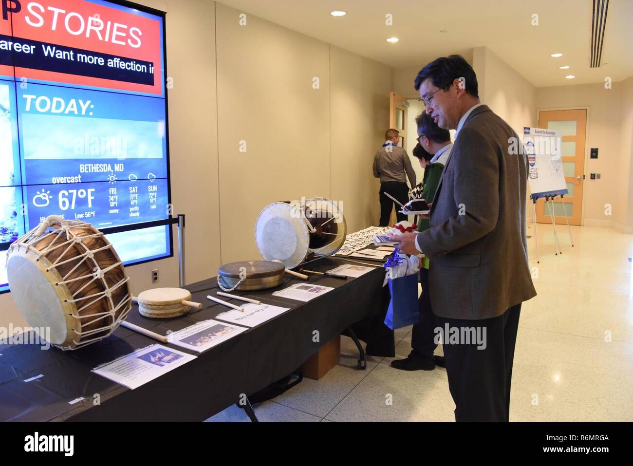 Dr. Paul Shang looks at a collection of musical instruments on display ...