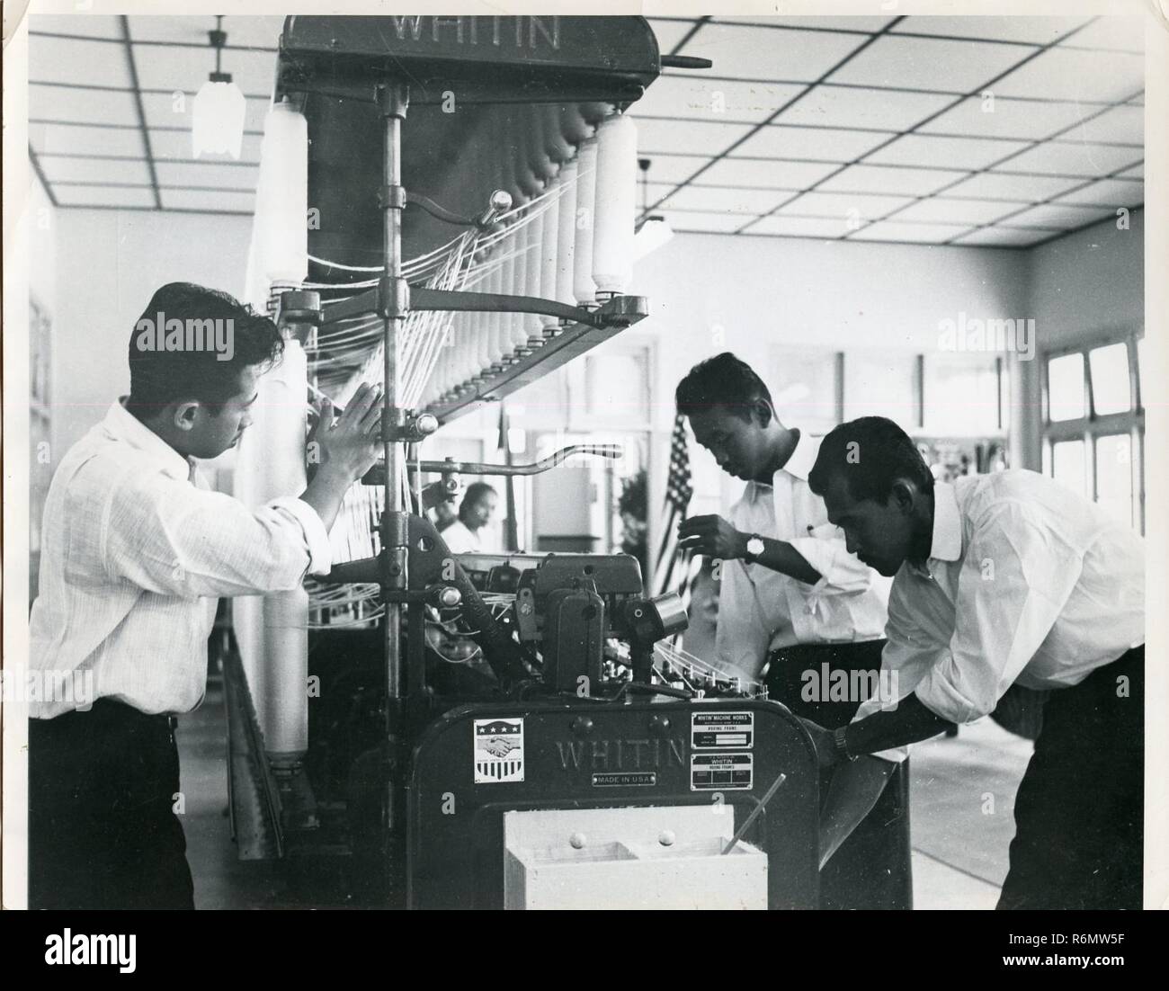 RESOURCE DEVELOPMENT INDONESIA Men working on Whitin spinning machine