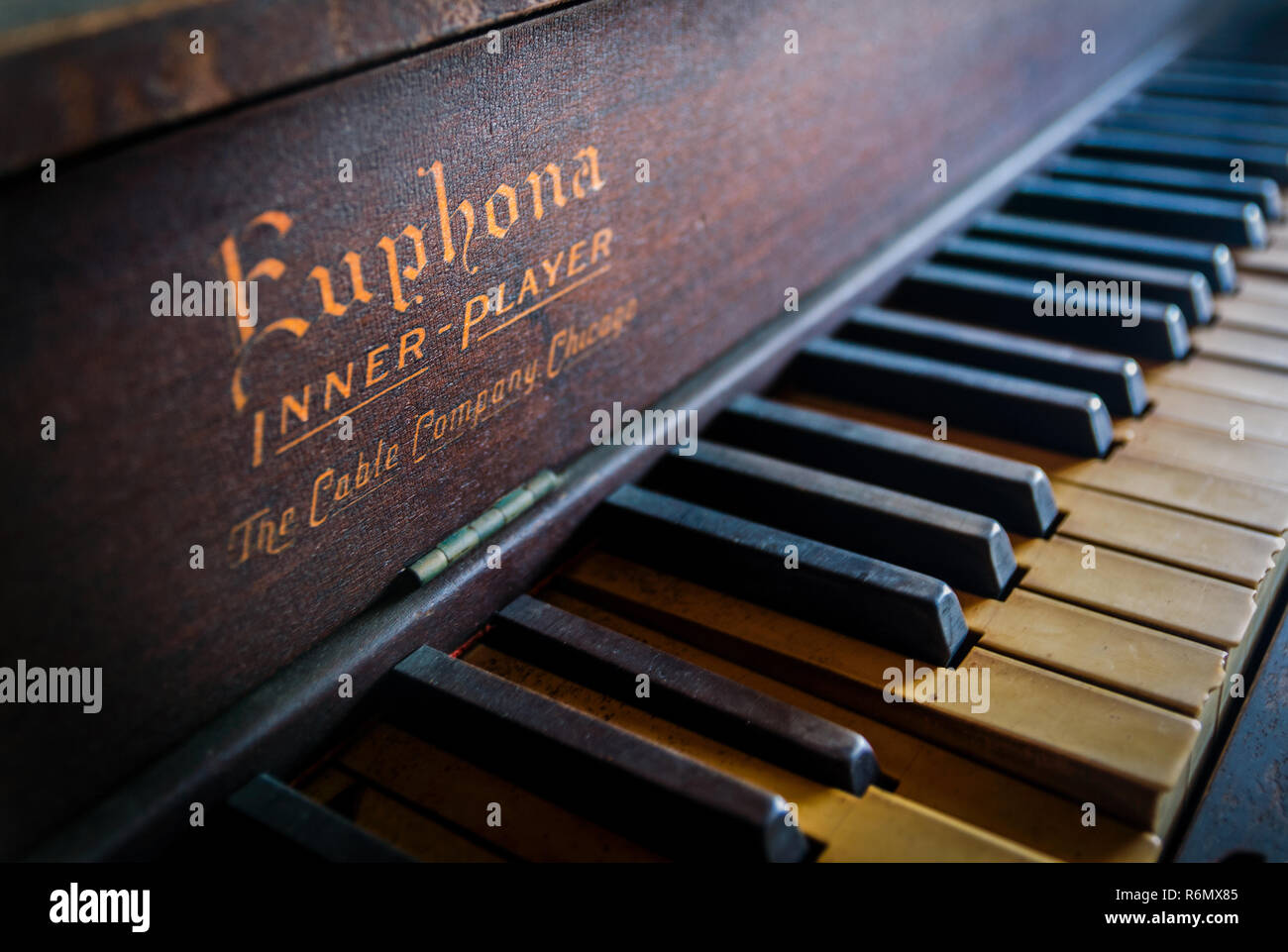 Morning sunlight streams across the keys of an antique Euphona Inner-Player  piano for sale at a thrift store in Reform, Alabama Stock Photo - Alamy