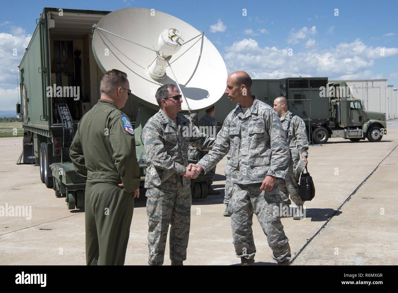233d Space Group Commander Col Thomas H. McKenna (right) shakes U.S. Air Force Chief of Staff General David L. Goldfein’s hand after a short discussion while Goldfien visited Buckley Air Force Base, Colo. and toured several static displays May 25, 2017. The 140th Wing, Colorado Air National Guard took the opportunity to showcase assets from their various missions to include the F-16C Fighting Falcon aircraft, the Mission Vehicle and Communications Vehicle from the 233d Space Group's Mobile Ground System, the 140th Explosive Ordnance Disposal Flight's Bomb Squad Emergency Response Vehicle and T Stock Photo