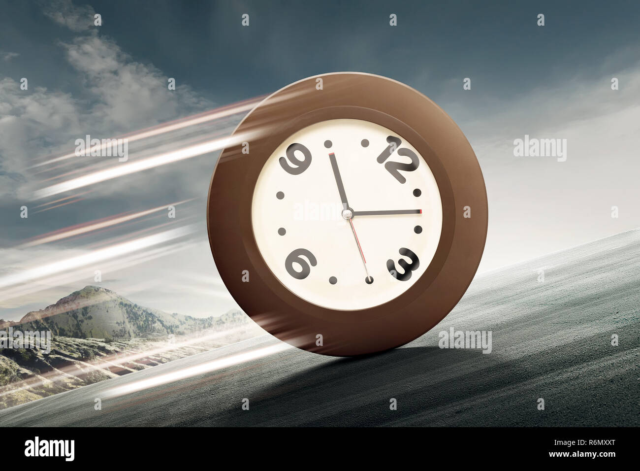 Analog clock rolling uphill Stock Photo Alamy