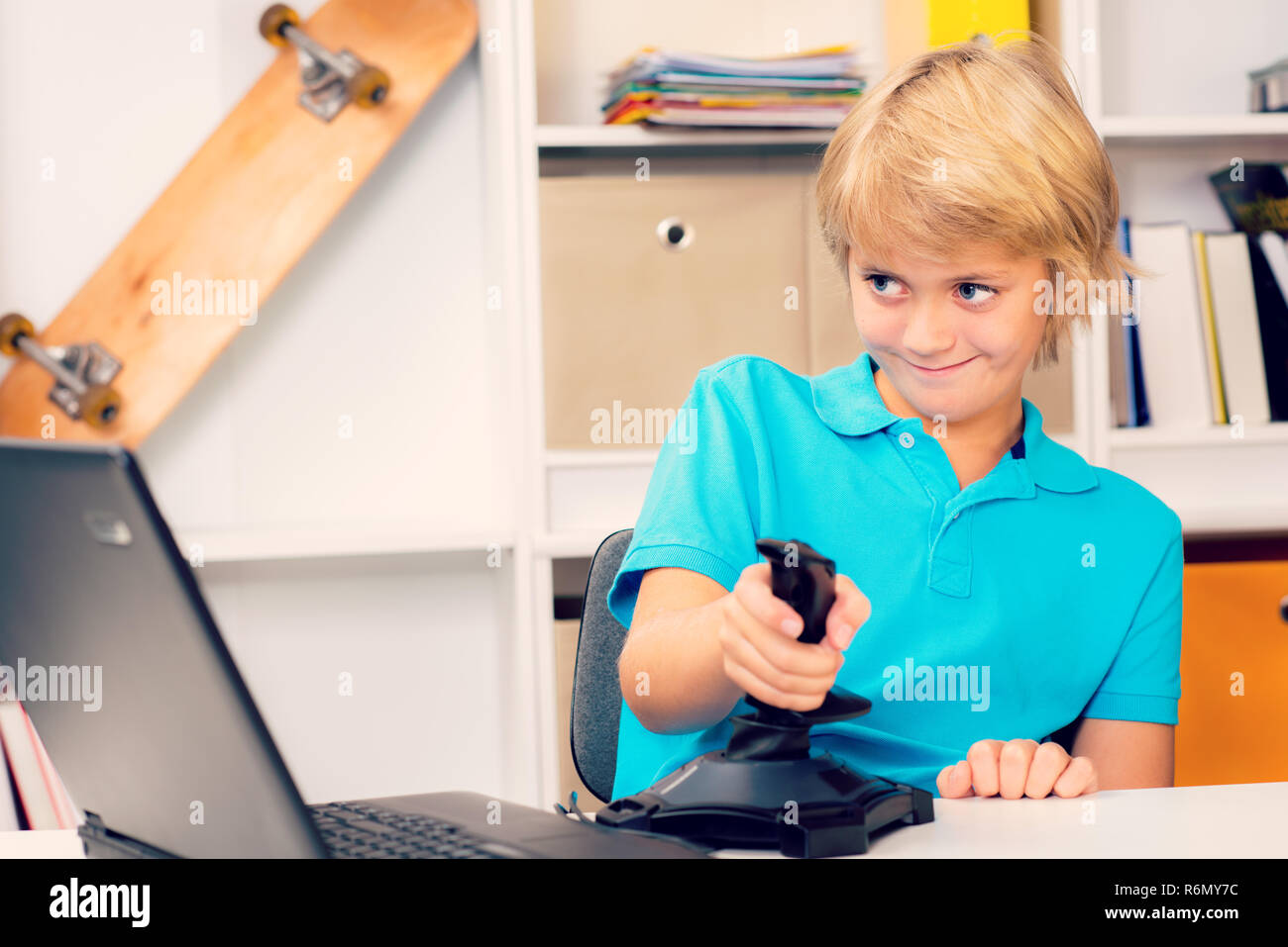boy is playing computer game Stock Photo - Alamy