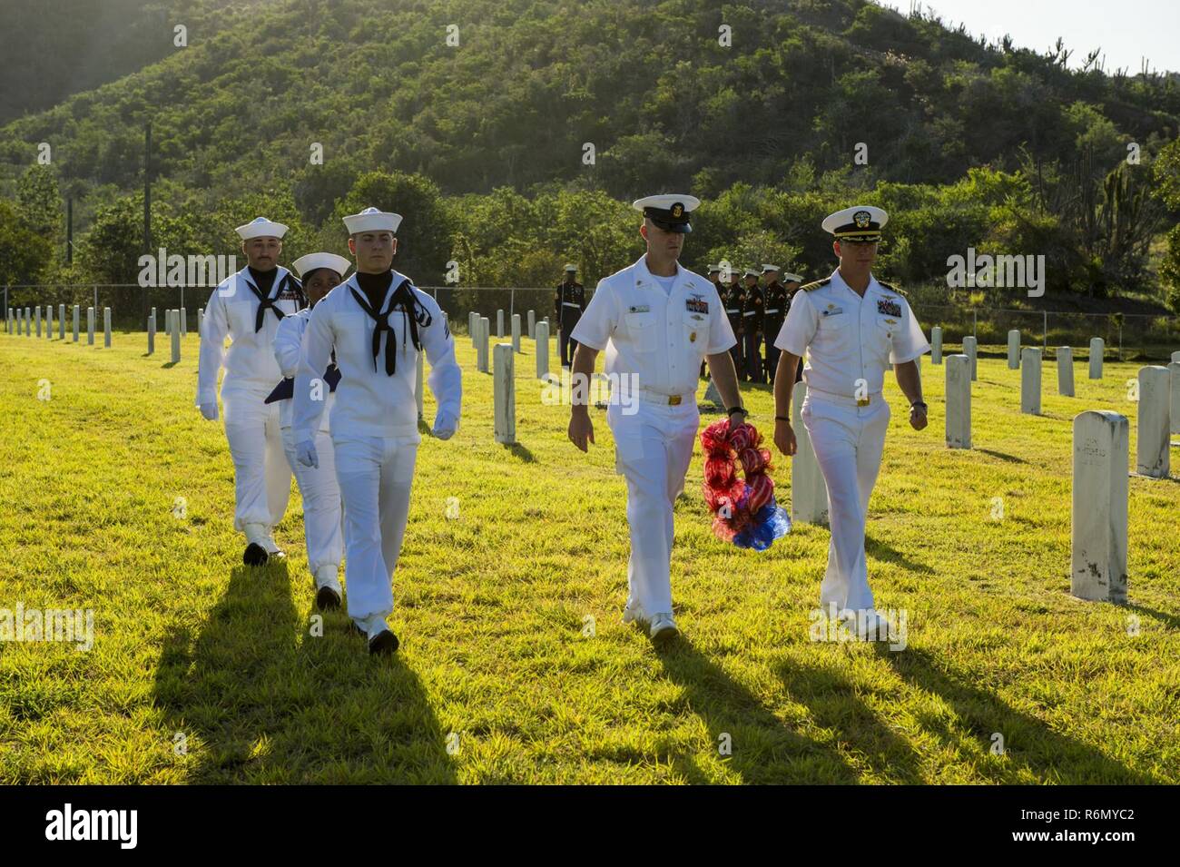 Naval Station Guantanamo Bay, Cuba (May 29, 2016)-Naval Station Guantanamo Bay’s Commanding Office Capt. David Culpepper and Command Master Chief Thomas Mace lay a wreath at Cuzco Wells Cemetery during a Memorial Day Ceremony Service. Capt. Culpepper Culpepper highlighted the brave Marines that died during the Battle of Cuzco Well during the Spanish American War. NSGB provides support to the U.S. Navy and U.S. Coast Guard vessels, and partner navies in the Caribbean operating area Stock Photo