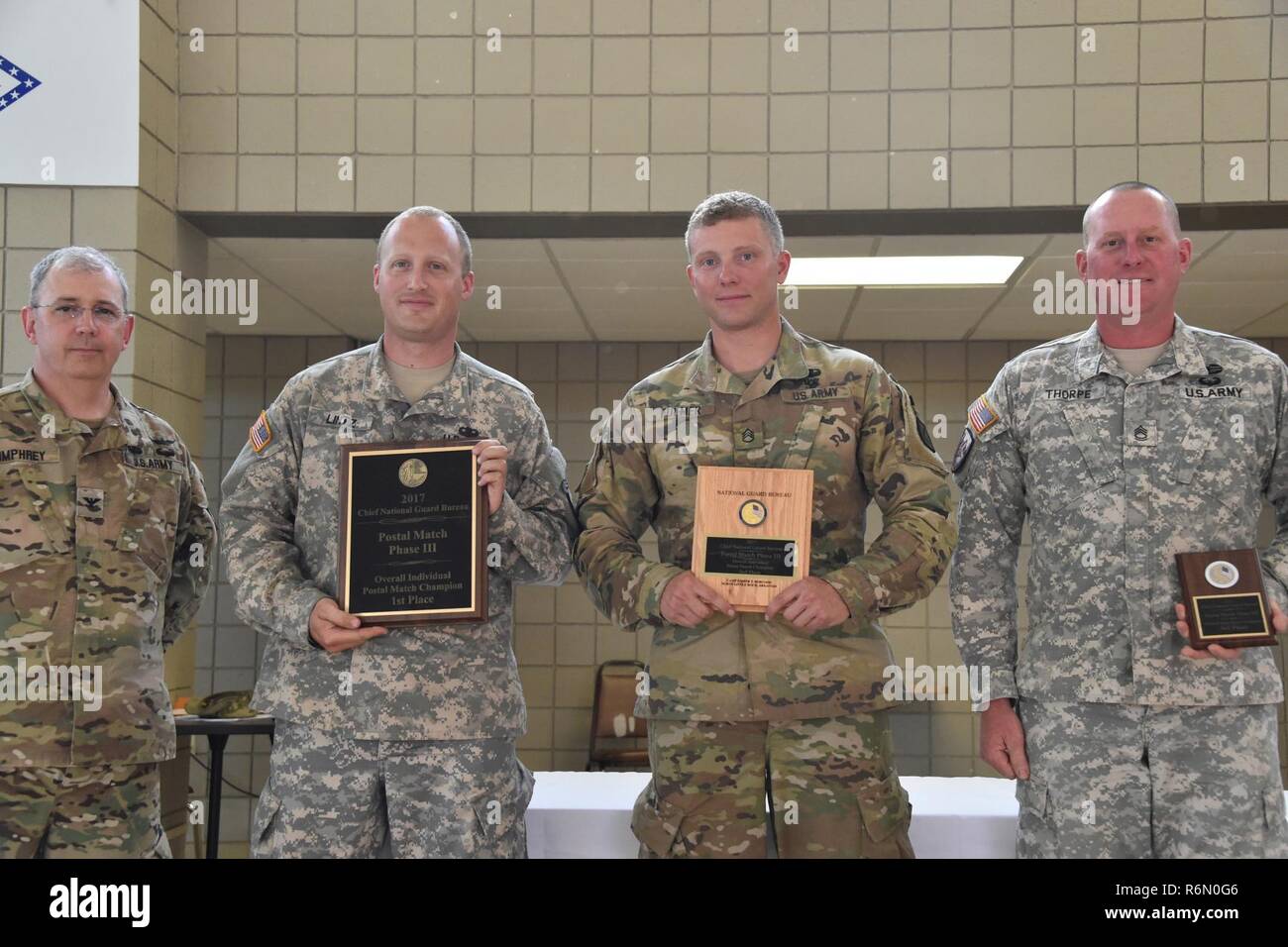 With a combined score of 2525-31X, 2nd Lt. Jonathan Lintz with the Nebraska National Guard achieved 1st place, Staff Sgt. Micah Fulmer with Colorado National Guard achieved 2nd place with a combined score of 2474-28X, and Sgt. 1st Class William Thorpe with Illinois National Guard with a combined score of 2460-28X achieved 3rd place. They are presented with CNGB Overall Championship Plaques by Col. Dennis Humphrey, National Guard Marksmanship Training Center Commander, May 25, 2017 at the completion of the CNGB Postal Matches, hosted by the National Guard Marksmanship Training Center held at Ro Stock Photo