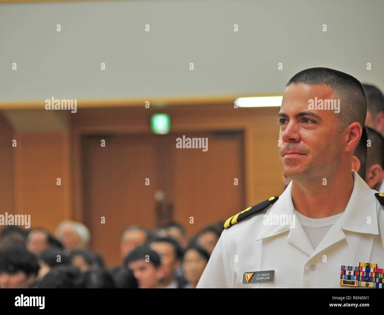 YOKOSUKA, Japan (May 20, 2017) - Lt. James Hicks, Naval Air Facility (NAF) Misawa's Command Chaplain, stands in line to accept an award during the 67th Annual Nippon Zenkokai Assocaition Awards Ceremony for outstanding community relations project support in Misawa, Japan.  Hicks organized a rehabilitation project completed by Japan and U.S. Service Members for a P-3 Orion aricraft located at Misawa's Aviation Museum.  He also coordinates an ongoing biweekly English training community relation project at one of Misawa's afterschool care centers.  The Nippon Zenkokai Association awards Service M Stock Photo