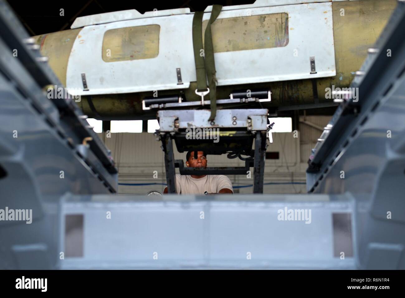 U.S. Air Force Senior Airman Travis Jones, 20th Aircraft Maintenance Squadron weapons load crew member, uses a bomb loader to carry a GBU-31 version one bomb during the annual Weapons Load Crew of the Year competition at Shaw Air Force Base, S.C., May 31, 2017. Load crews, comprised of three Airmen, raced against the clock and tried to beat the current record time of 25 minutes. Airmen had to load a GBU-31, AIM-9M and AIM-9X Sidewinder missile, as well as the M61A1 Vulcan 20 mm rotary cannon quickly in efficiently to gain points towards victory. Stock Photo