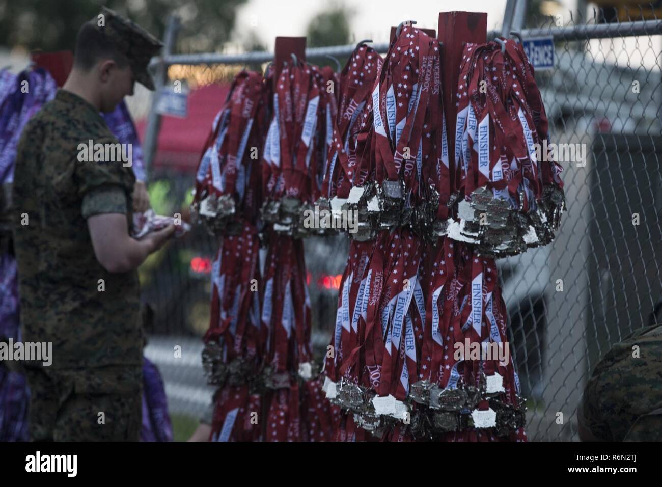 U.S. Marines prepare medal racks for finishers of the 10th Annual ...