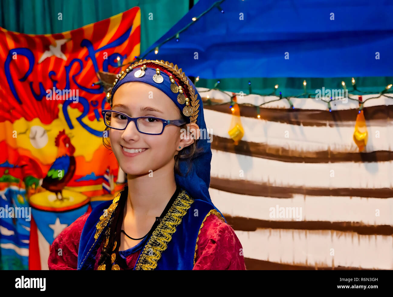 A teenage girl dressed in traditional Puerto Rican clothing smiles at the 34th annual Mobile International Festival, Nov. 17, 2018, in Mobile, Alabama Stock Photo