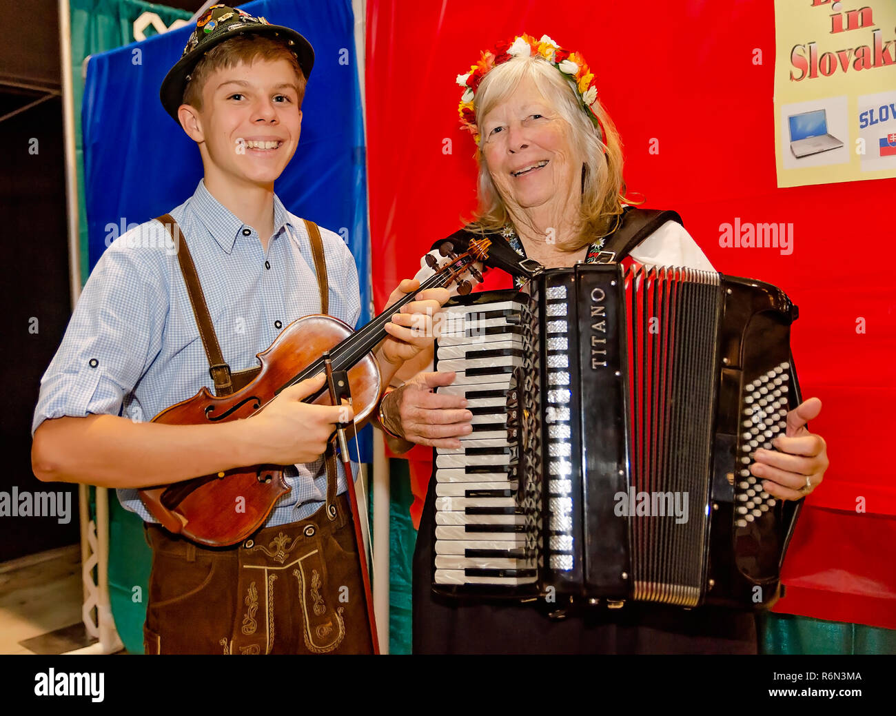 A violinist and accordionist pose for a photo at the 34th annual Mobile International Festival, Nov. 17, 2018, in Mobile, Alabama. Stock Photo
