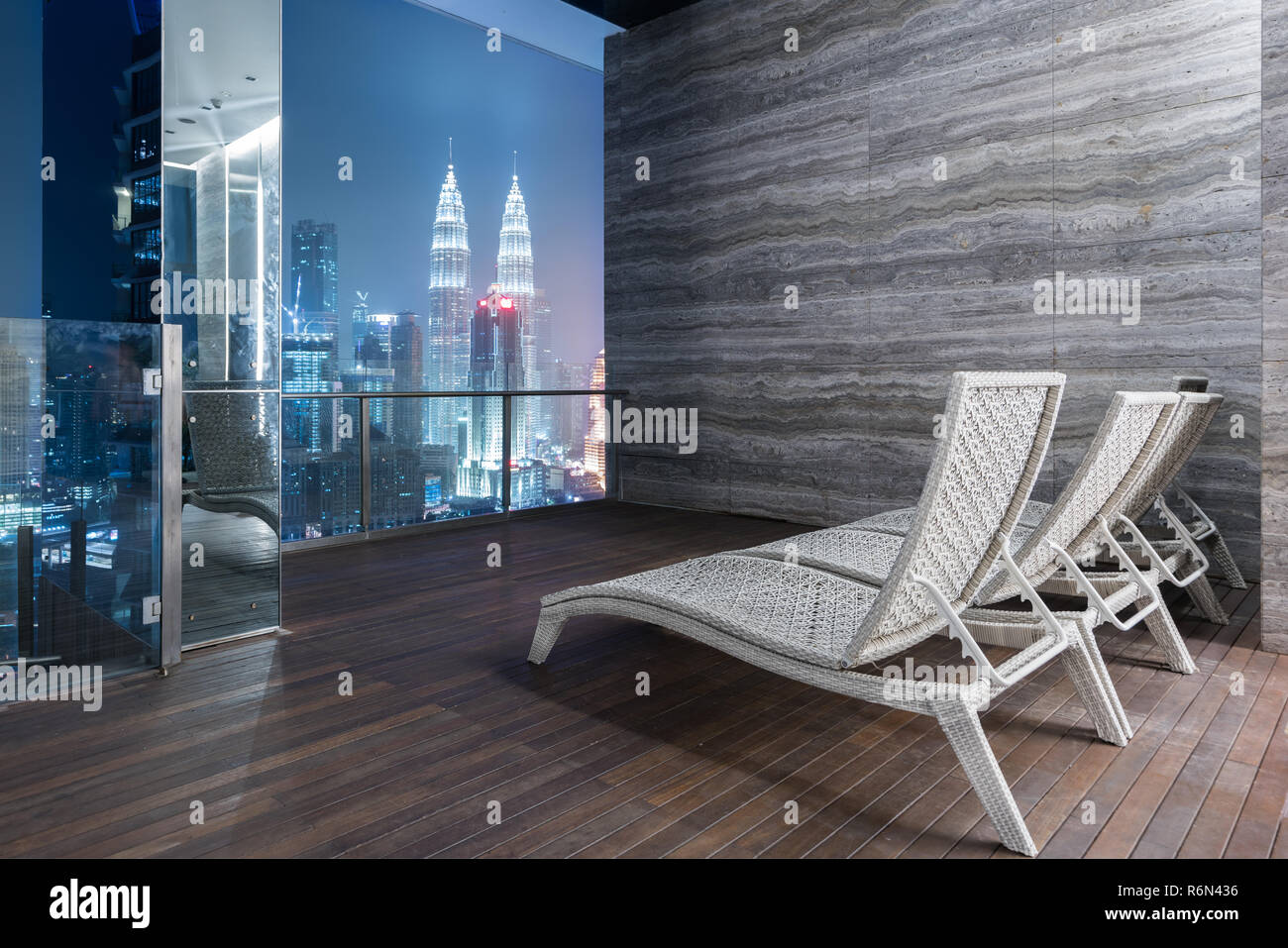 Lounge Bar on rooftop bar or rooftop highrise with great night view of Kuala Lumpur and Petronas Twin Towers in Malaysia. Stock Photo