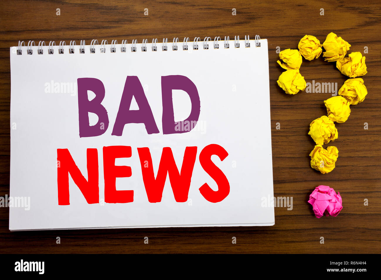 Conceptual hand writing caption inspiration showing Bad News. Business concept for Failure Media Newspaper written on notepad note paper on the wooden background with question mark. Stock Photo
