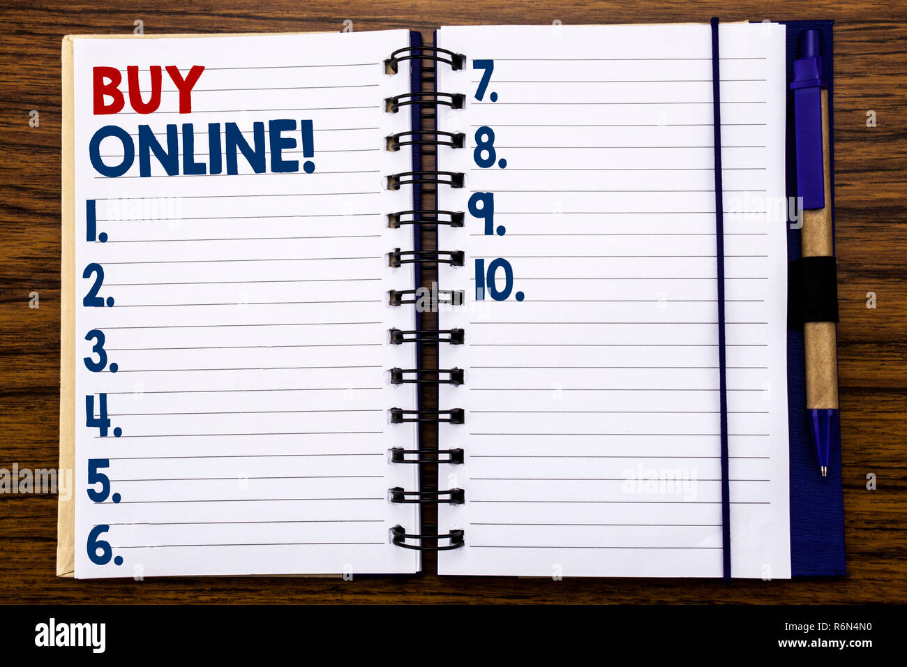 Writing text showing Buy Online. Business concept for E-commerce Sale Purchase Written on notebook note paper, wooden background with pen and marker. Stock Photo