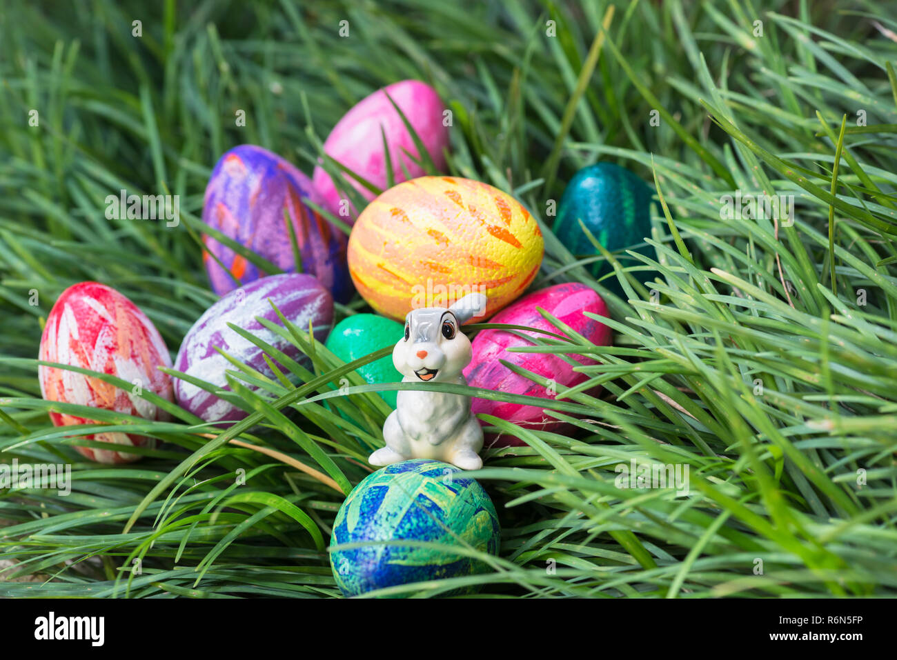 Easter bunny and eggs on the green grass Stock Photo - Alamy