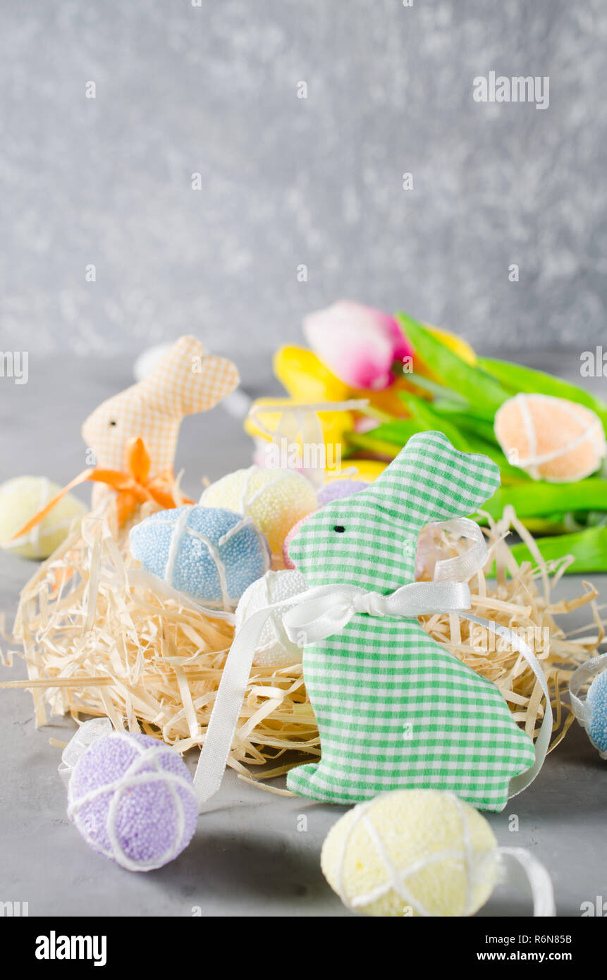 Easter composition with bunnies, eggs and tulips. Stock Photo