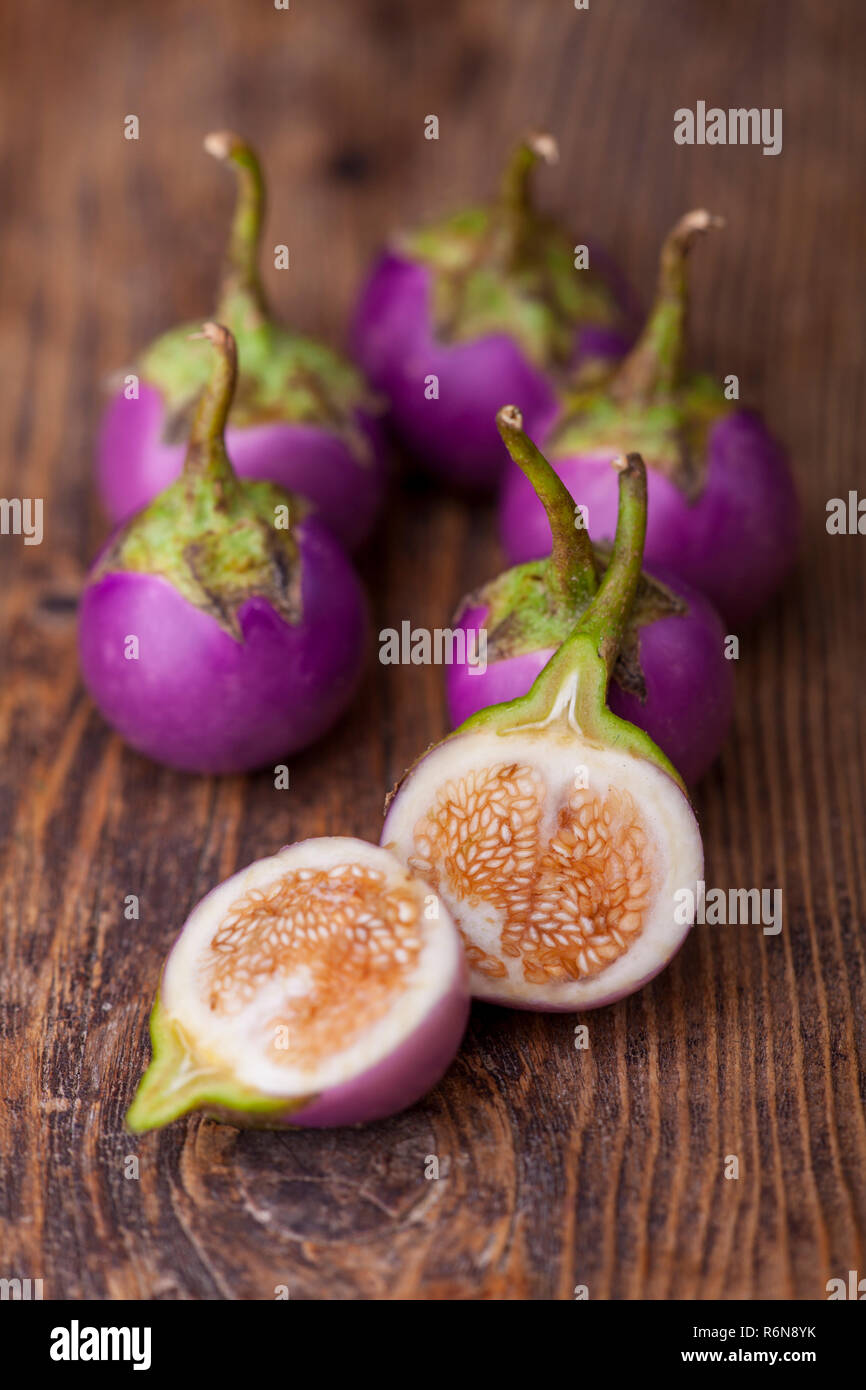 asian eggplants on dark wood Stock Photo