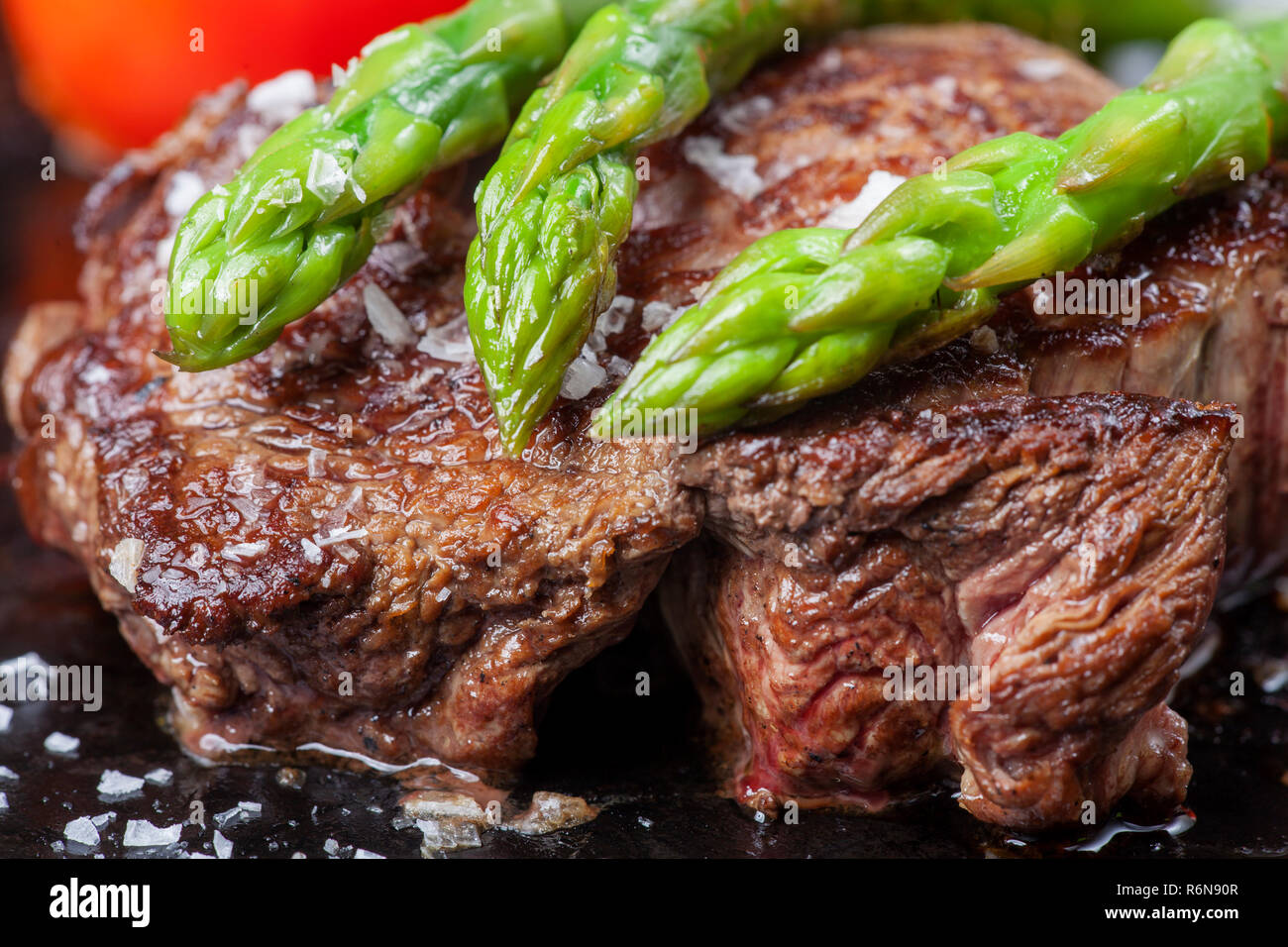 beef steak and green asparagus in a pan Stock Photo