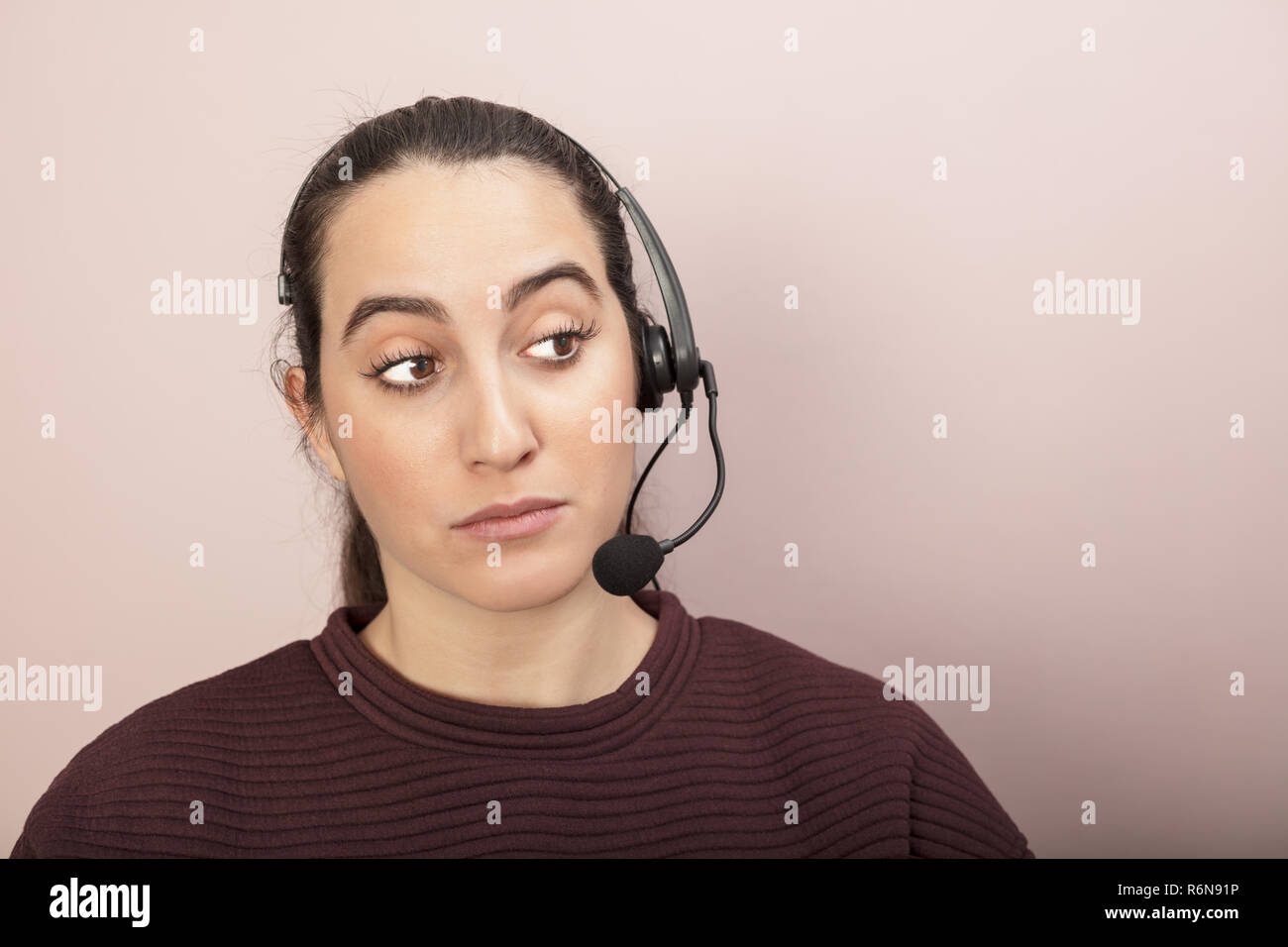 Sceptical Help Desk Operator Listening To A Call Stock Photo