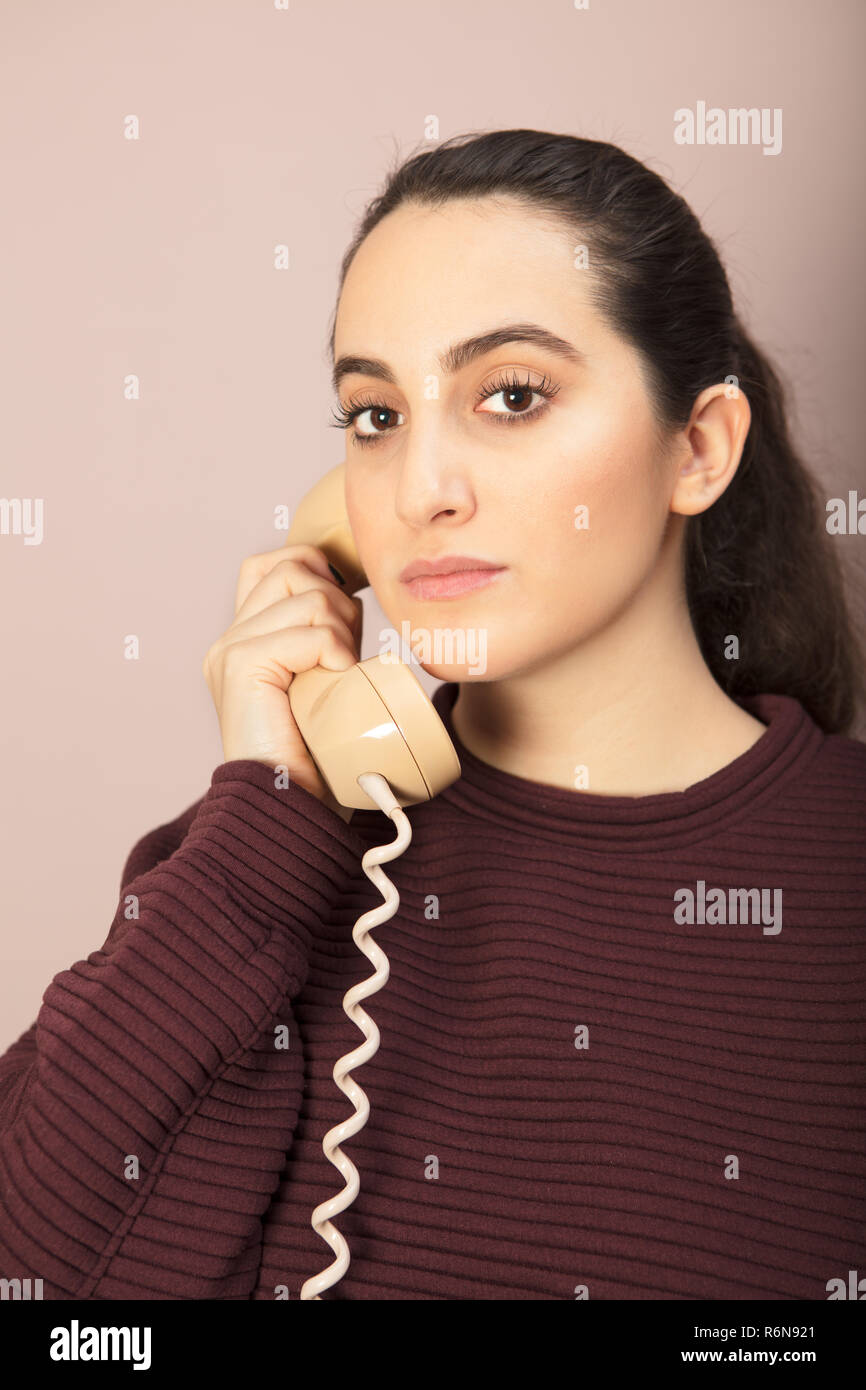 Attractive woman listening to a phone conversation Stock Photo - Alamy