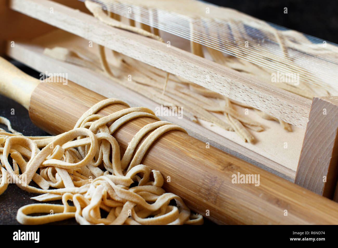 Making tagliolini pasta alla chitarra with a tool Stock Photo Alamy