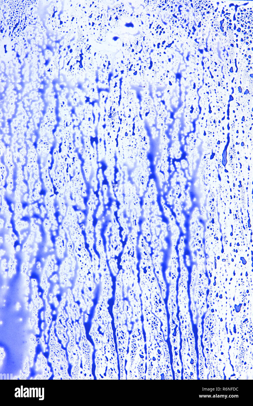 Blue dropping splatter on white surface Stock Photo