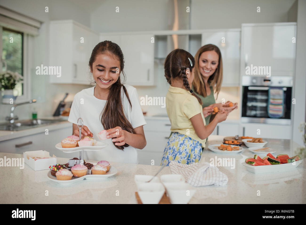 Young Girl Sorting the Cakes Stock Photo - Alamy