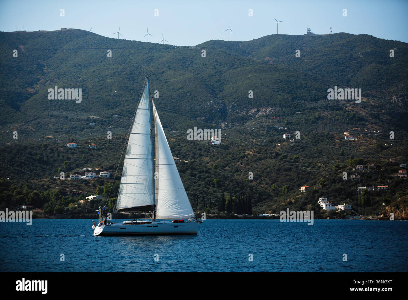 Sailing yacht glides near the Greek coast in the Aegean sea Stock Photo ...