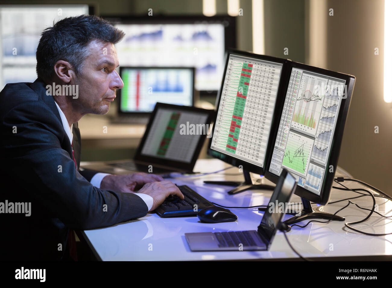 Stock Market Broker Analyzing Graph On Multiple Computer Screen ...