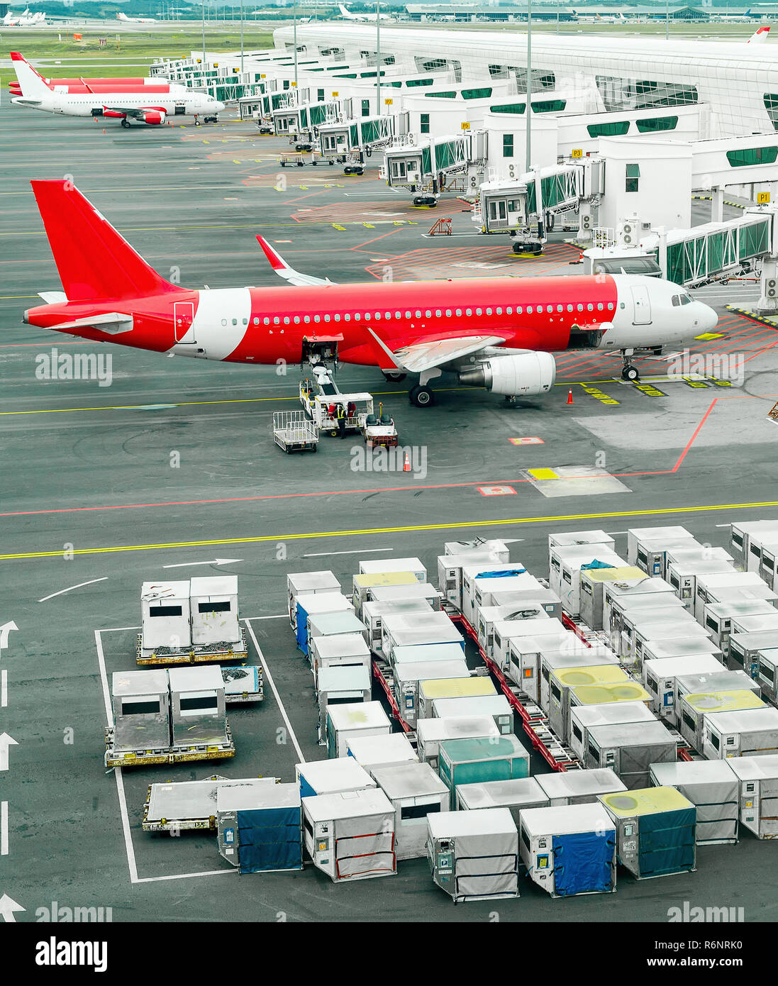 Airplanes and freight containers in airport of Kuala Lumpur, Malaysia Stock Photo