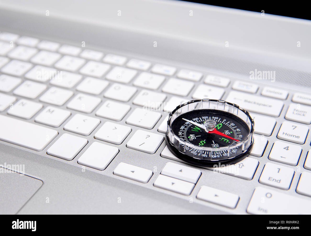 Laptop keyboard and compass, navigation concept Stock Photo