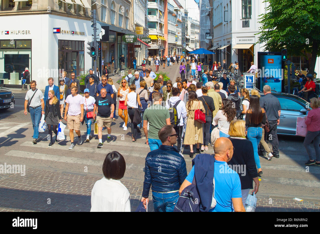COPENHAGEN, DENMARK - JUNE 14, 2018: People crossing the road at Copenhagen central shopping street. Copenhagen is the capital of Denmark. Stock Photo