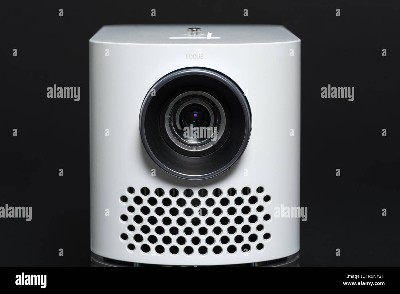 Stylish mini home cinema LED projector, lightweight tech gadget Stock Photo