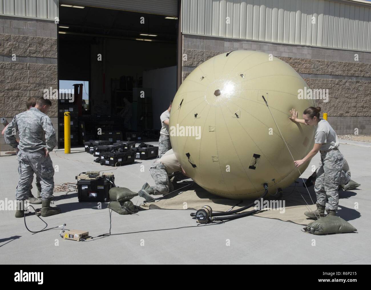 Members of the 726th Air Control Squadron assemble a Small Communications Package May 30, 2017, at Mountain Home Air Force Base, Idaho.  The inflatable system allows smaller teams to transport and employ it without relying on outside agencies. Stock Photo