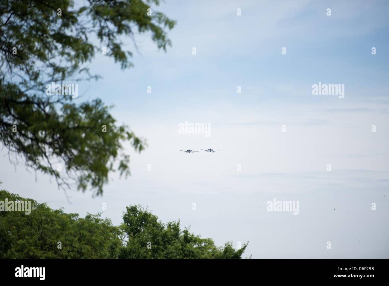 Two 122nd Fighter Wing A-10 Warthogs perform a flyover following the
