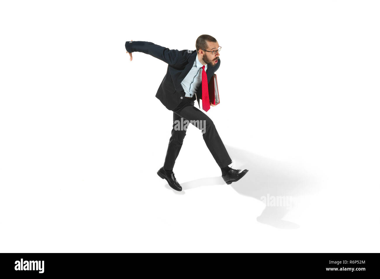 Businessman running with a folder on white background Stock Photo
