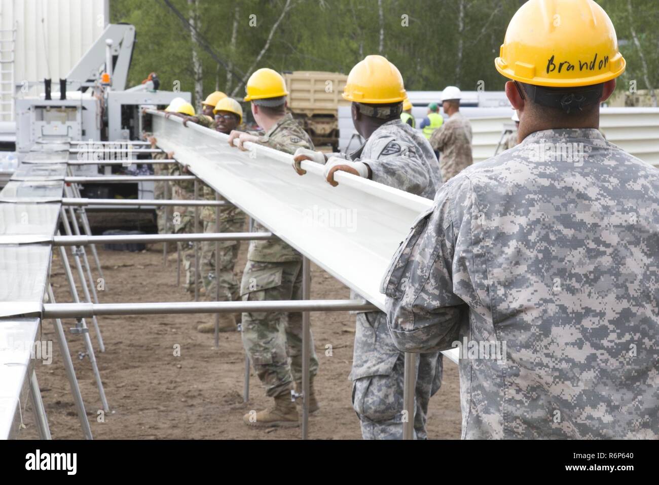 Soldiers From The 902nd Engineer Company 15th Engineer Battalion Load A K Span Building Machine Alongside Service Members From The United States Air Force And The U S Navy S Seabees During The Construction Of Soldiers From The 902nd Engineer Company 15th Engineer Battalion Load A K Span Building Machine Alongside Service Members From The United States Air Force And The U S Navy S Seabees During The Construction Of