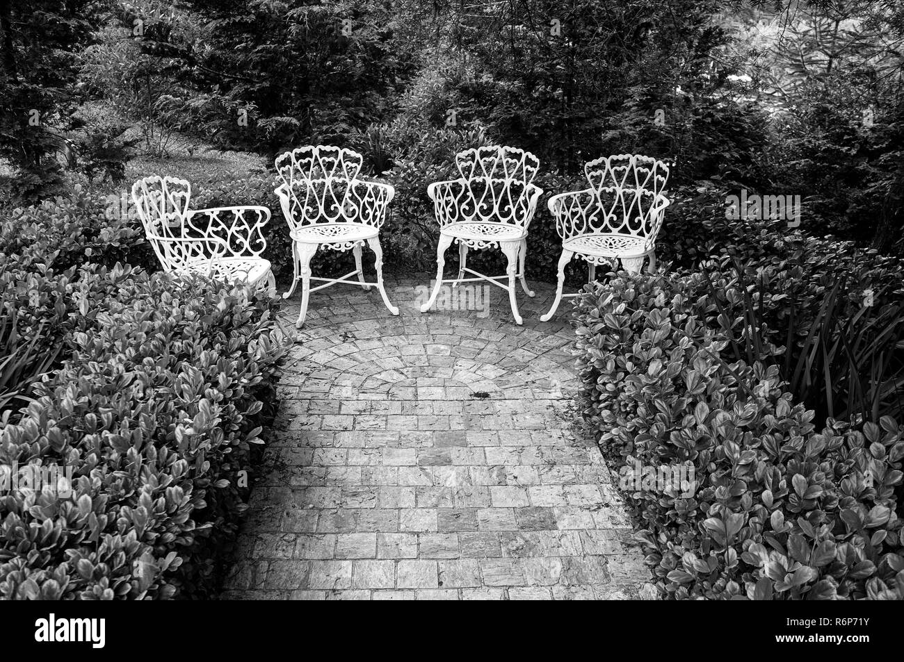 rock tiles path  end  garden chairs  black white Stock Photo