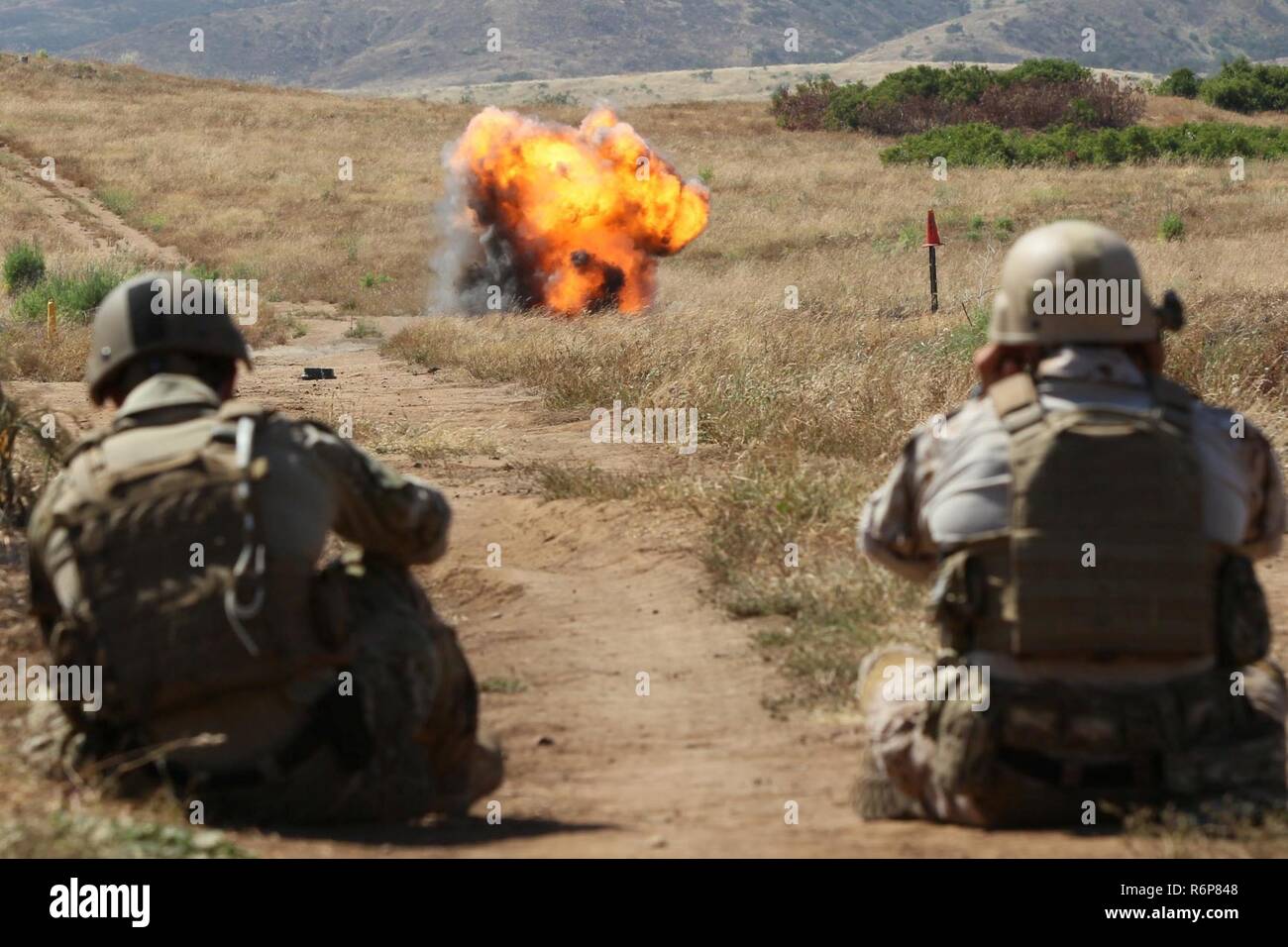 CAMP PENDLETON, Calif. (May 3, 2017) Marines from 1st Combat Engineer Battalion watch as Naval Surface Warfare Center (NSWC), Corona Division Detachment Fallbrook Expeditionary Systems Evaluation Division engineers conduct a test and evaluation of the Anti-Personnel Obstacle Breaching System (APOBS). APOBS is a length of detonating cord with attached grenades that is carried over an obstacle or minefield by a rocket to clear a safe path. NSWC Corona personnel collected data, while Marines from 1st Combat Engineer Battalion, Camp Pendleton, Calif., and Navy Explosive Ordnance Disposal technicia Stock Photo