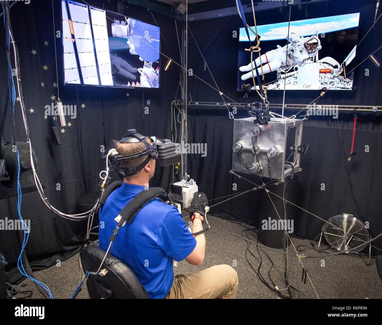 NASA Astronaut Col. Tyler "Nick" Hague's progress is monitored on video  screens during a virtual reality training scenario for use of the  Simplified Aid for EVA Rescue (SAFER) pack to return to